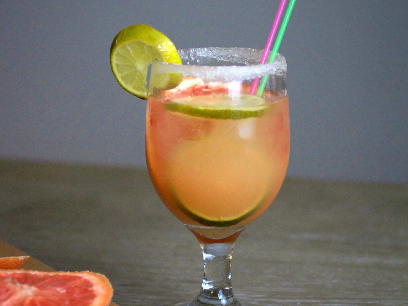 Grapefruit beverage in a glass with limes