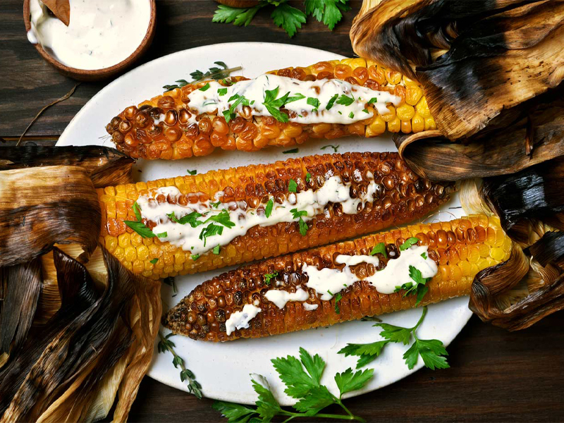 Mexican corn on a dish with cilantro