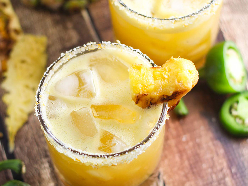 pineapple jalapeno margarita in a glass with ice