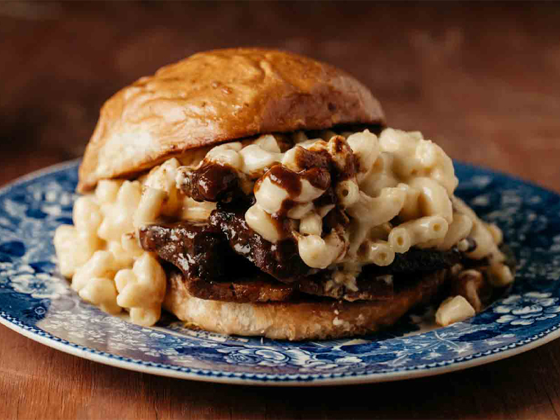 Burger with macaroni and cheese on top