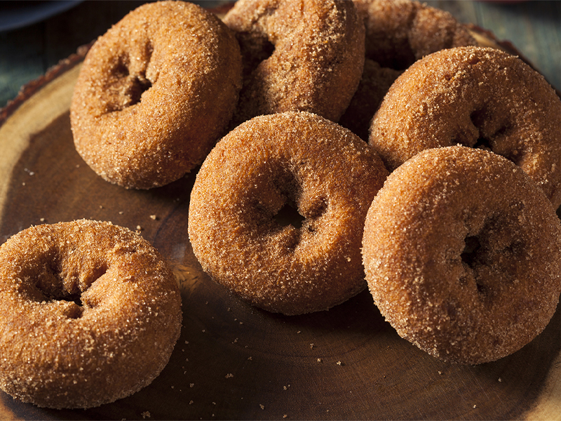 Dutch oven donuts prepared on wood dish