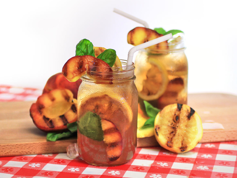 peach basil arnold palmer beverage in a glass