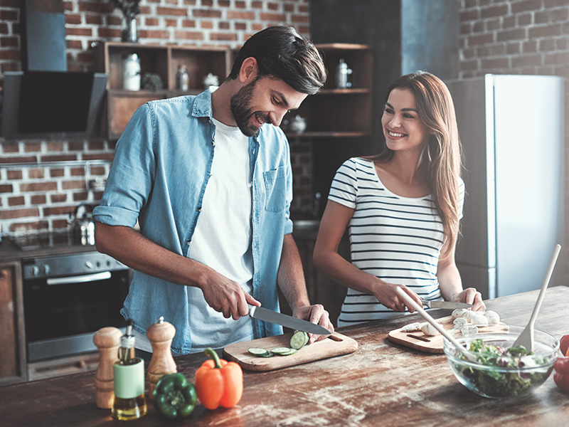 Couple in Kitchen preparing food