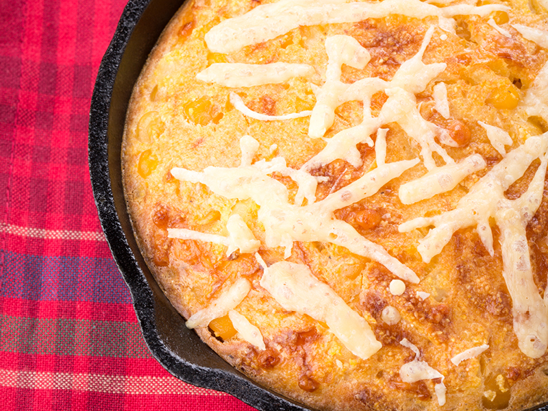 Bacon and cheddar cornbread in a cast iron skillet