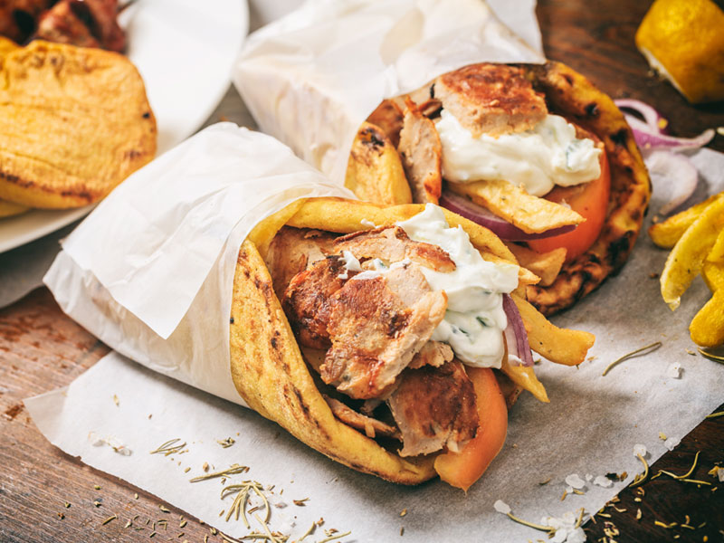 Chicken Gyros in paper wrap on a counter
