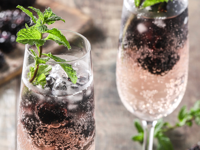 Grilled blackberry champagne in wine glass