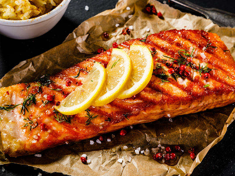 Grilled beer-marinated salmon garnished with lemon