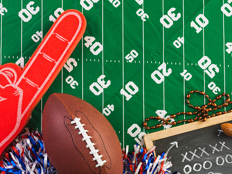 green football tablecloth with football fan paraphernalia 