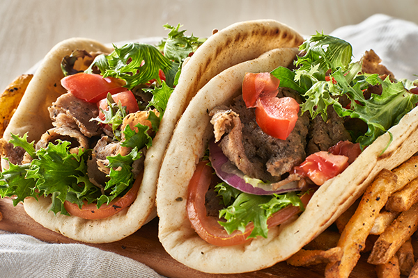 Two gyros served in a wood basket