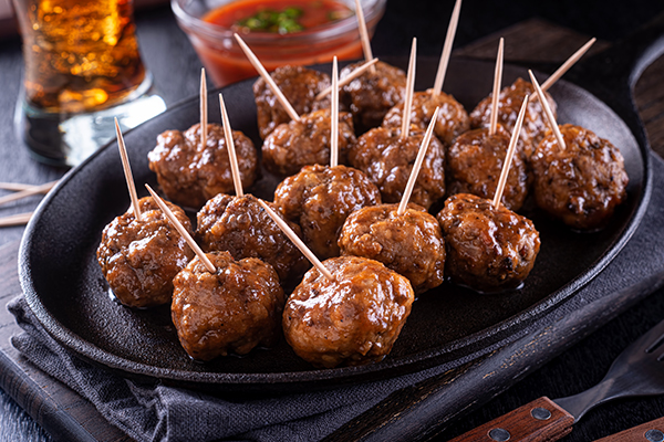 Grilled Meatballs served on a plate with toothpicks