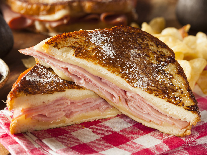 Grilled Monte Cristo sandwich on plaid napkin