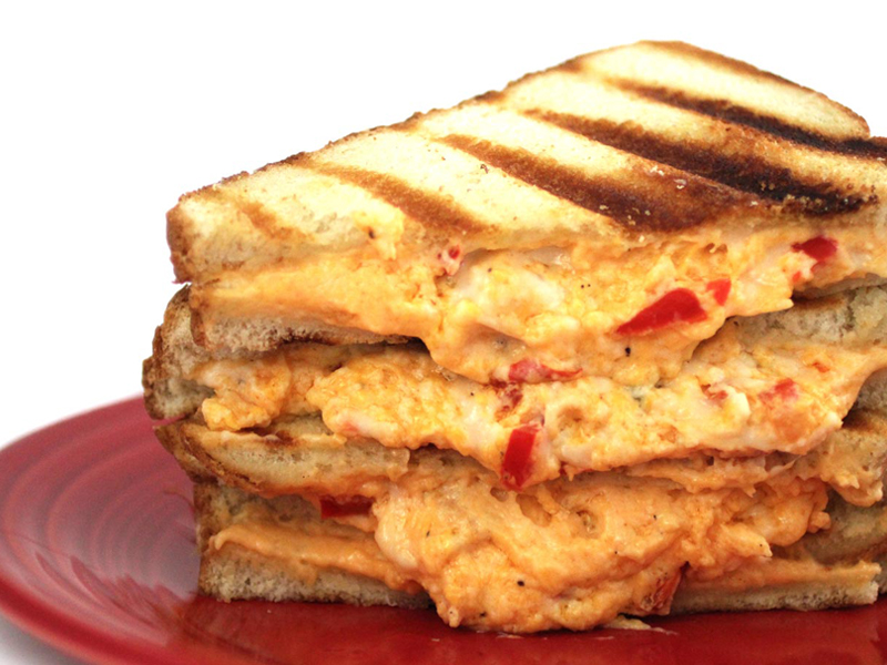 Grilled pimento cheese sandwich sliced on plate