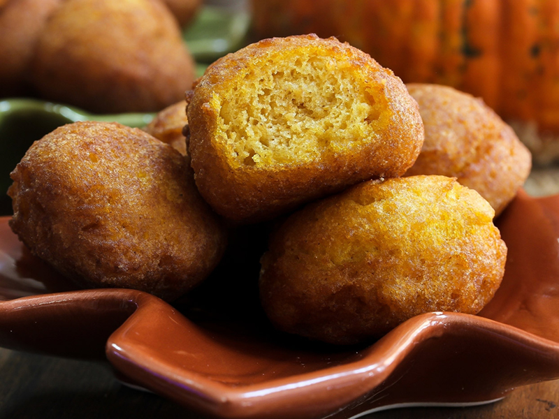 Yellow fried pumpkin fritters stacked