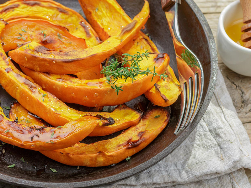 Sliced grilled pumpkin in iron dish