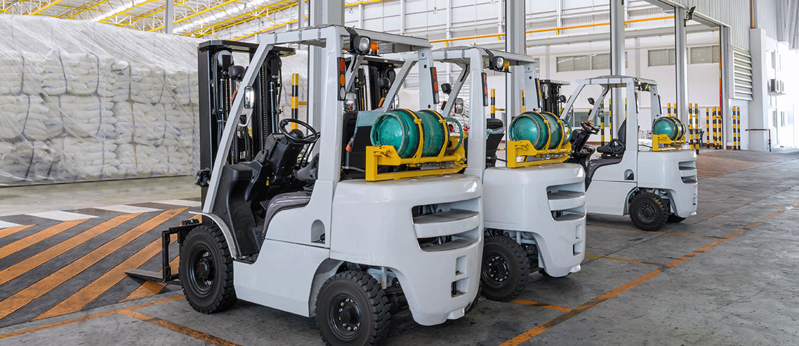 Row of parked forklifts.