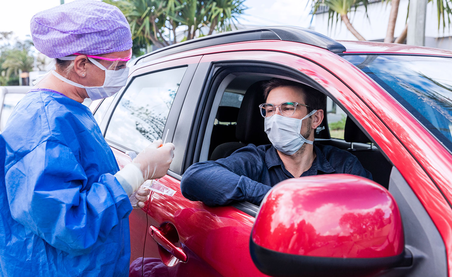 Healthcare worker testing man wearing mask