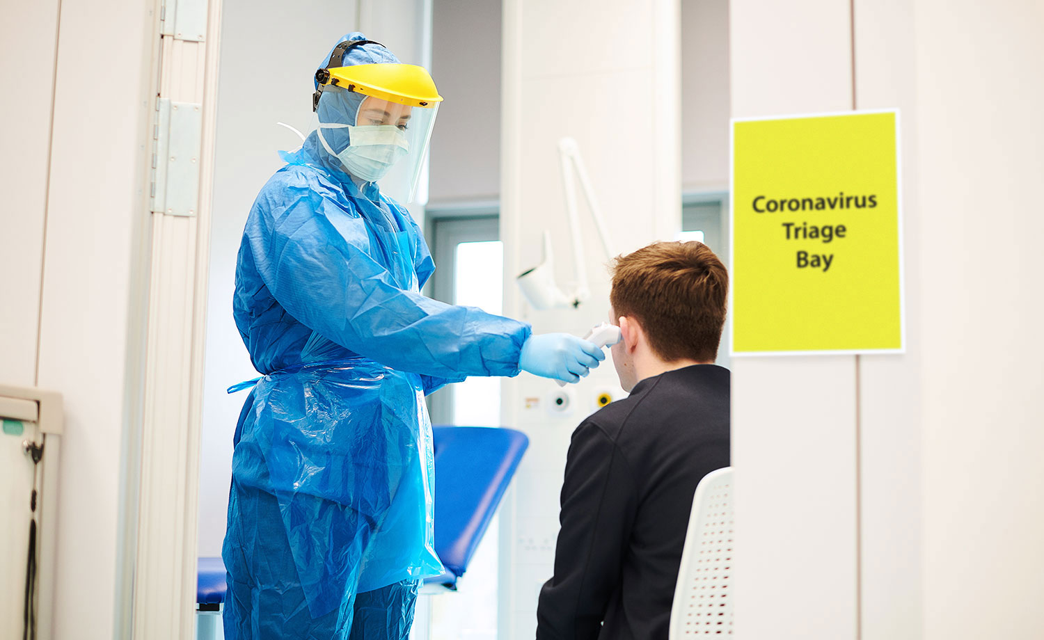 Healthcare worker taking man's temperature