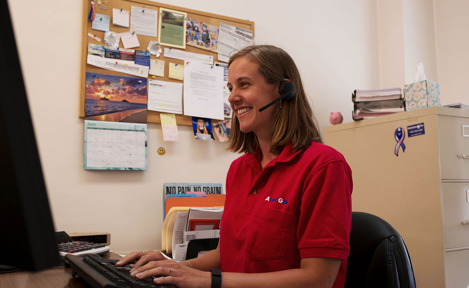 AmeriGas employee with headset on at computer 