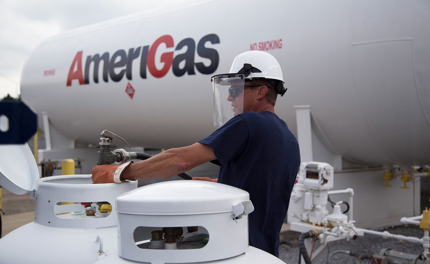 AmeriGas employee filling smaller tanks from a larger tank