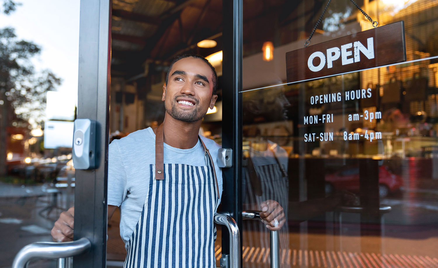 Restaurant employee opening door.