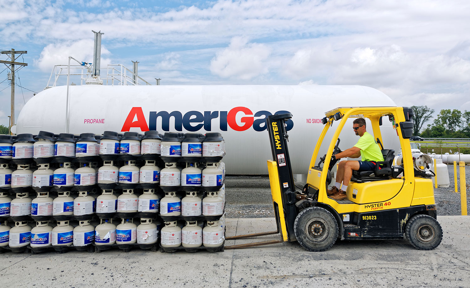 Man driving forklift in a propane workyard.