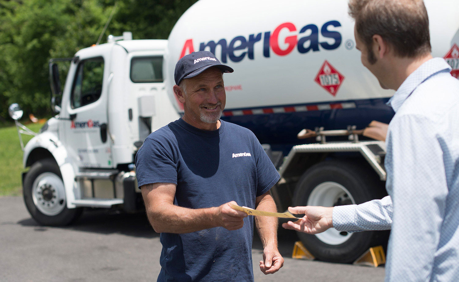 Two men standing in front of an AmeriGas truck.