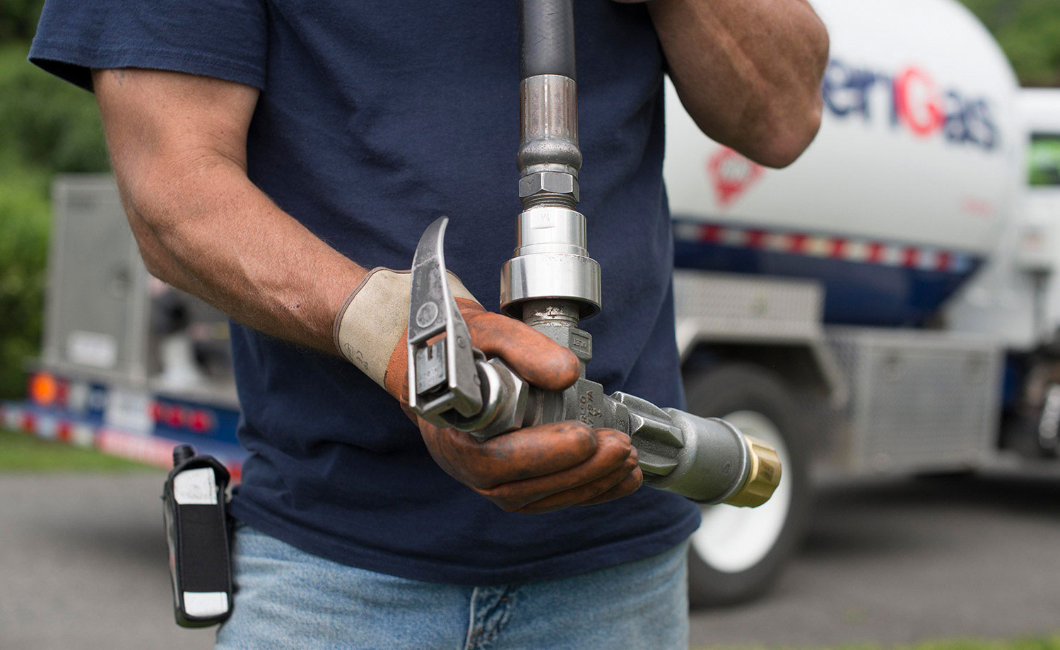 Man holding propane line valve.