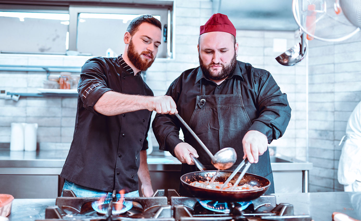 Two chefs cooking.