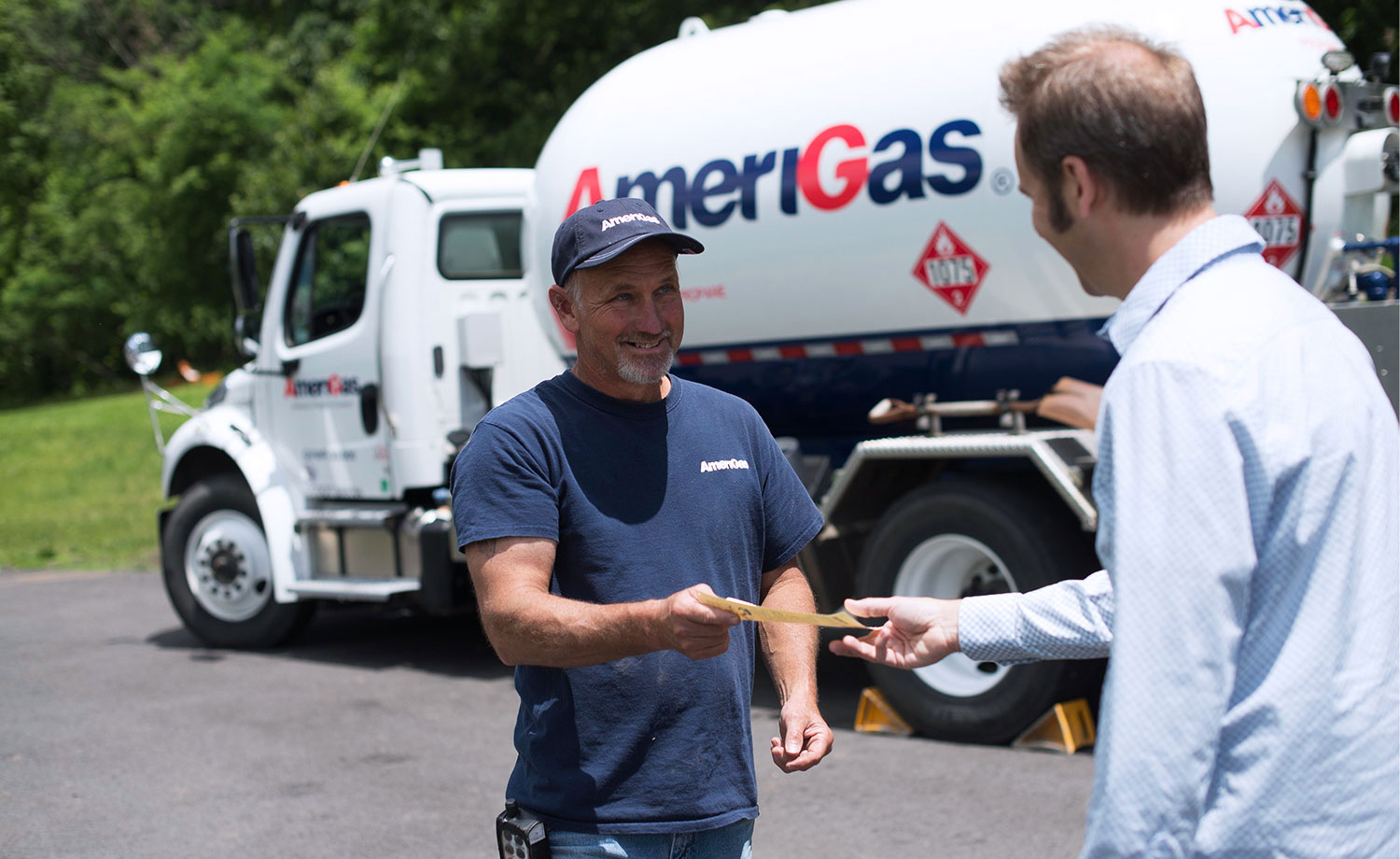 Two men standing in front of an AmeriGas truck.