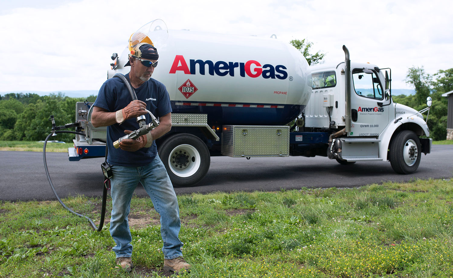 Man carrying propane line.