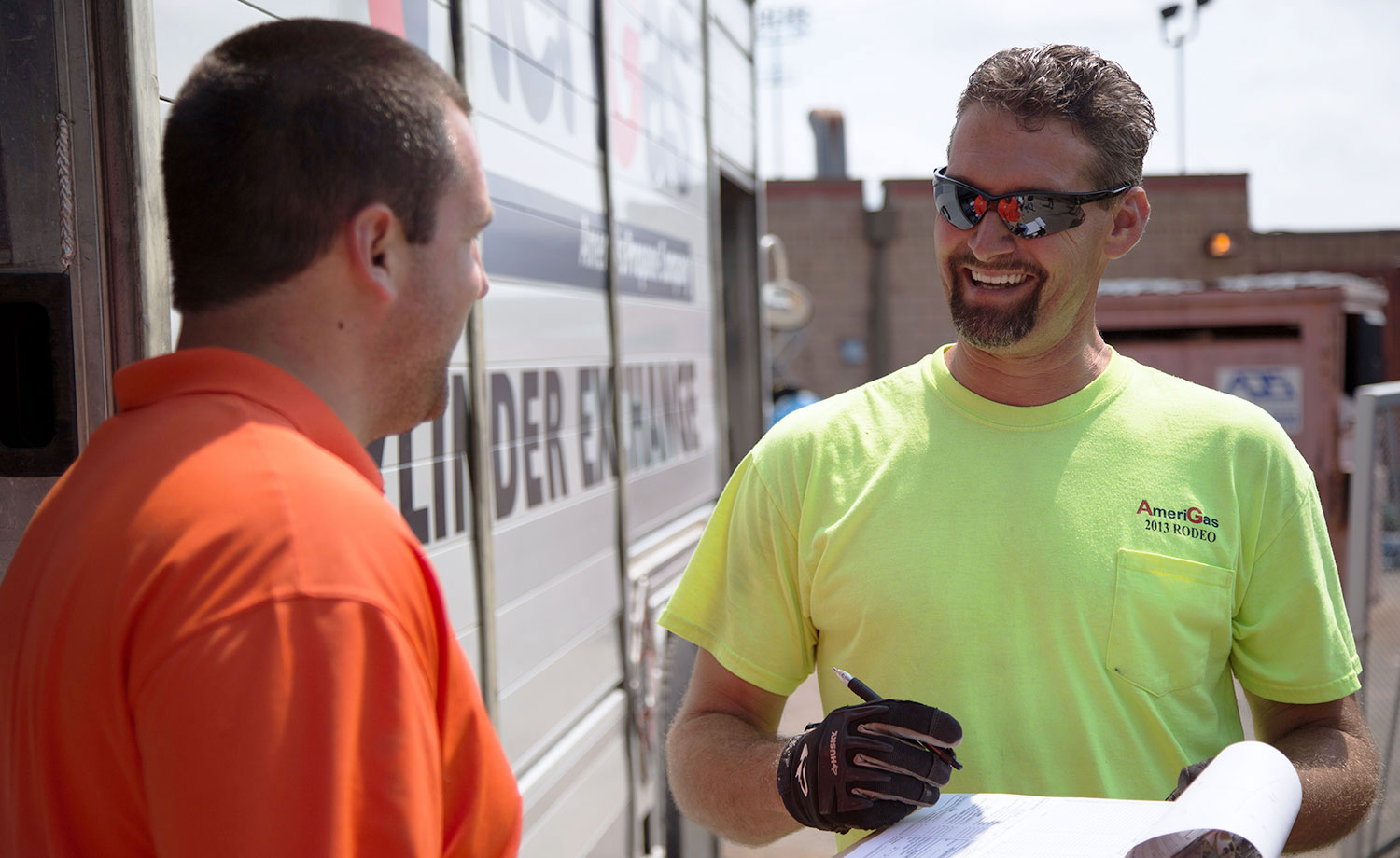 Two men with clipboard in front of an AmeriGas truck.