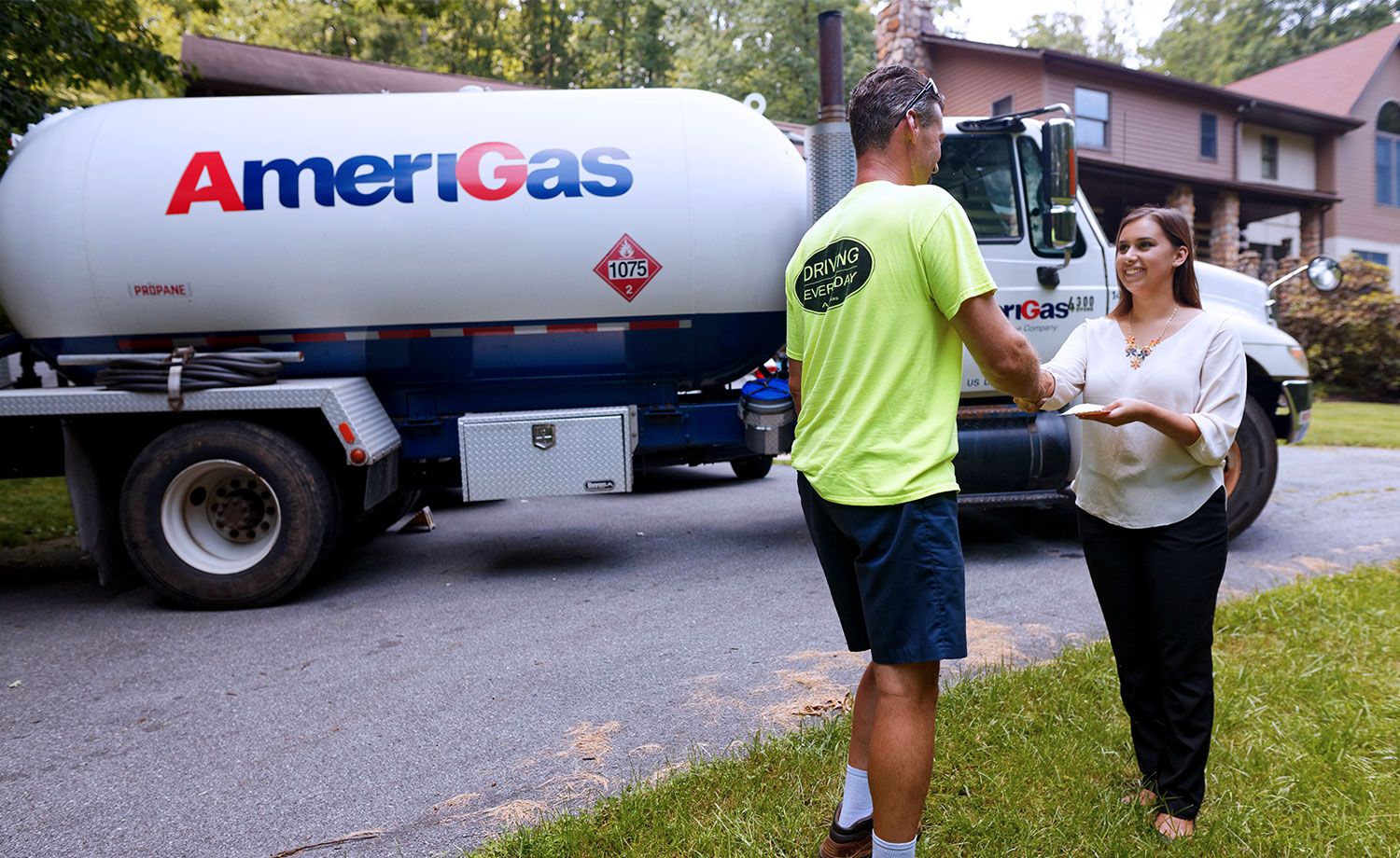Man and woman shake hands in front of Amerigas truck