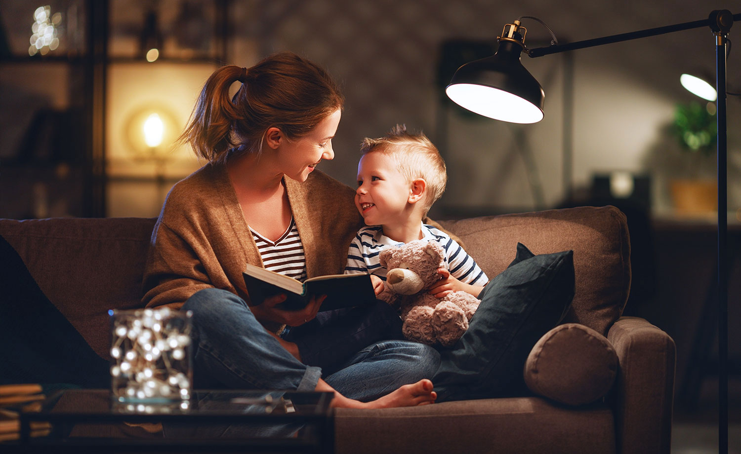 A woman reading to her son in her propane powered home