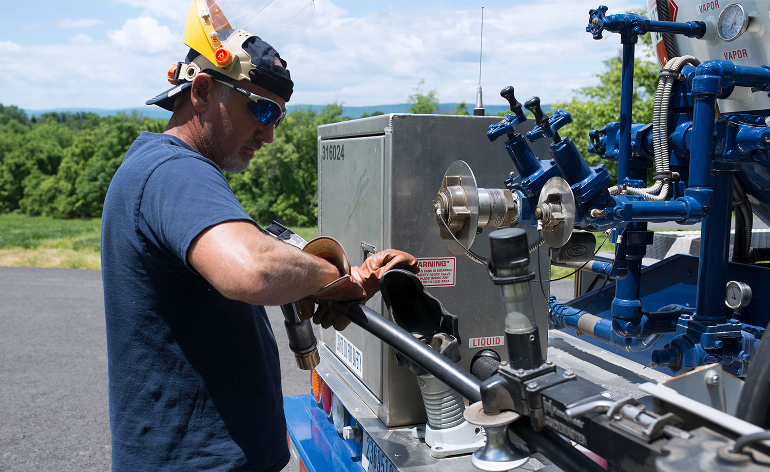 AmeriGas employee preparing for propane tank service at truck