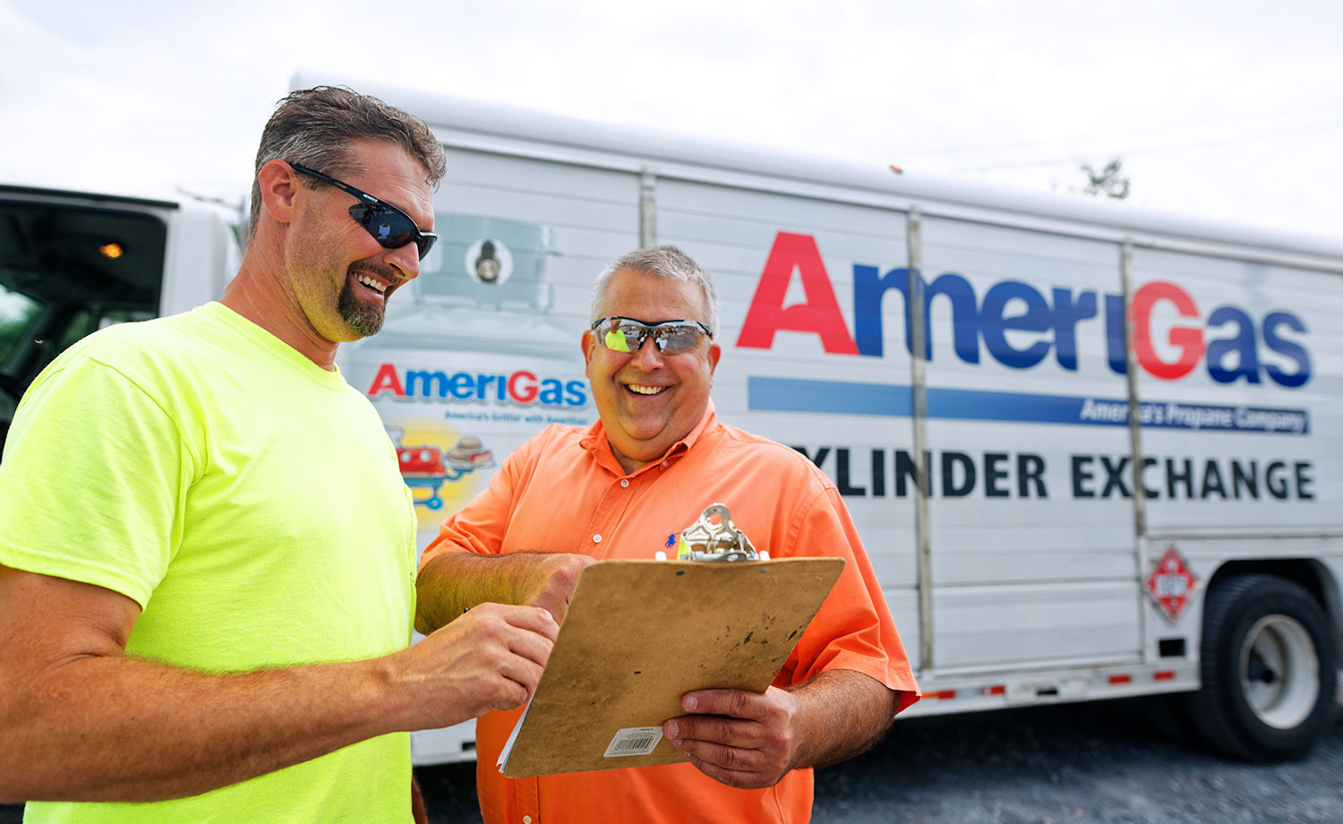 Two men with clipboard in front of an AmeriGas truck.