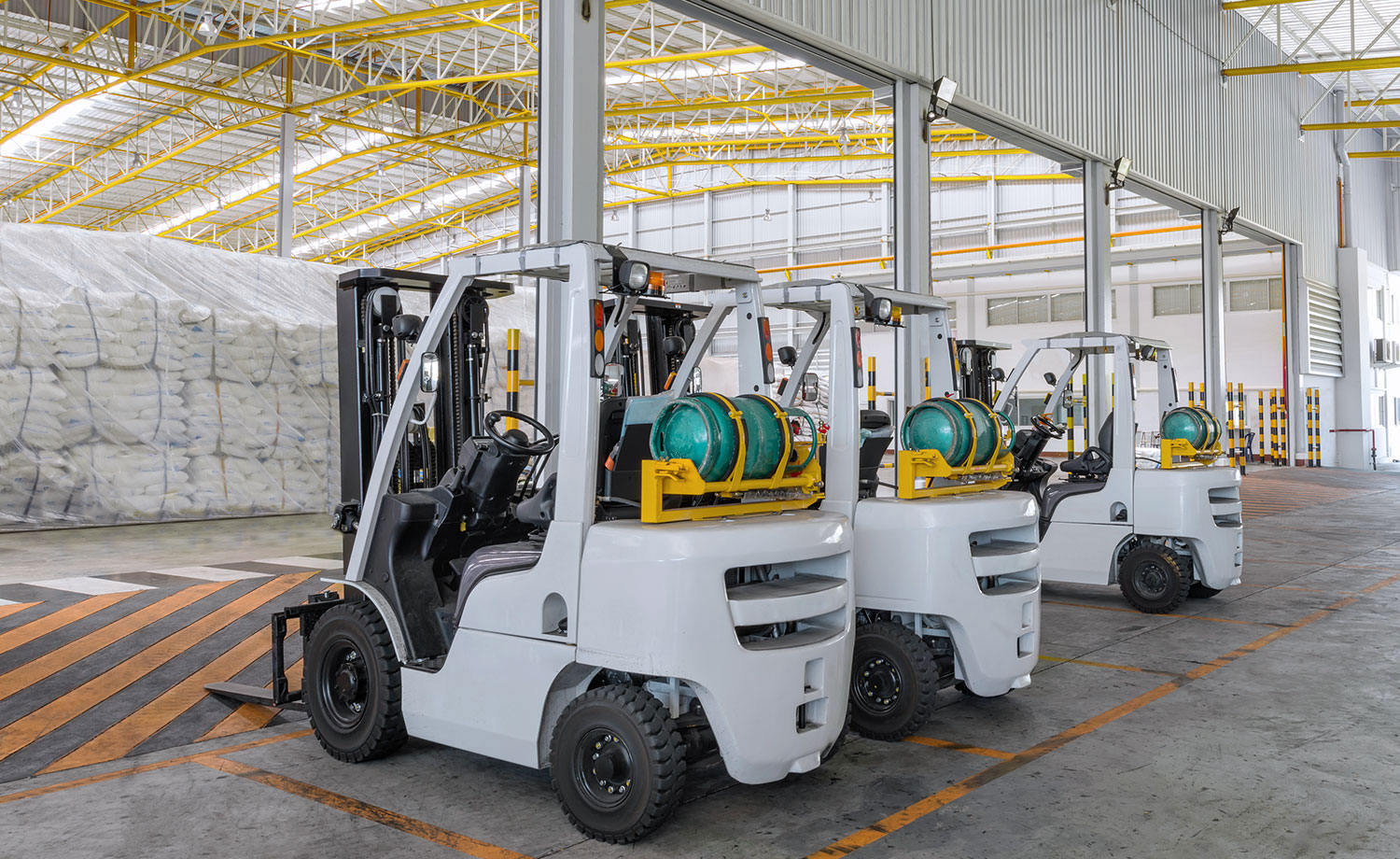 Row of parked forklifts.