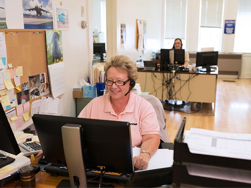 Woman at computer on headset