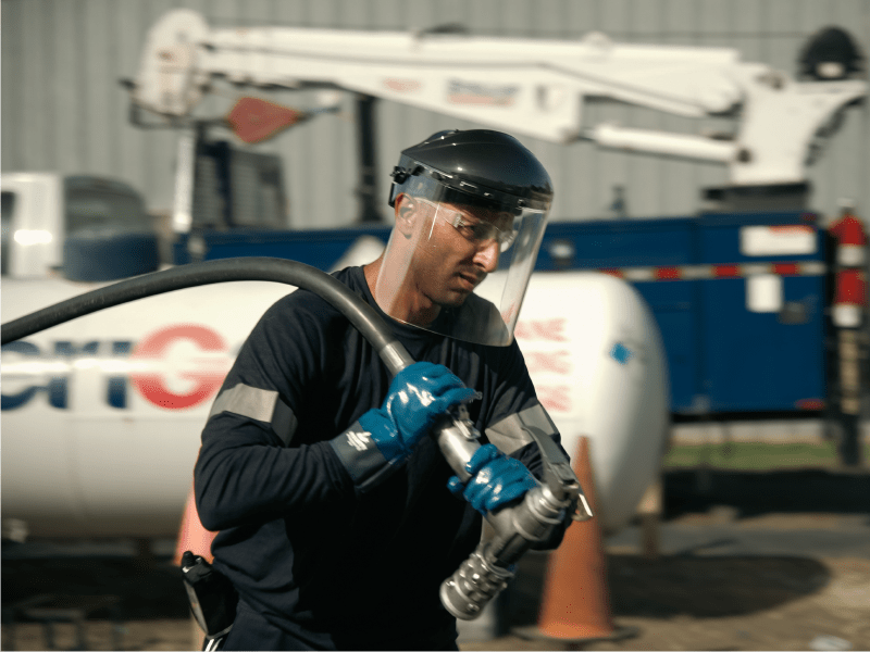 AmeriGas propane truck with delivery driver holding propane hose