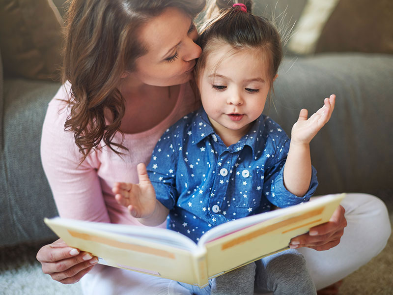 Mother reading to child.