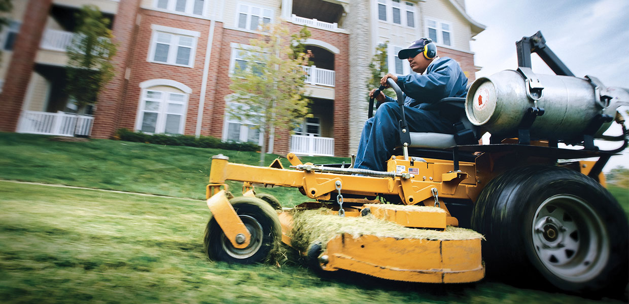 Propane lawn mower in use.
