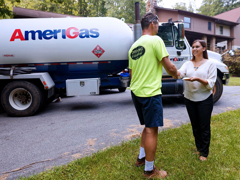 Man and woman shake hands in front of AmeriGas truck