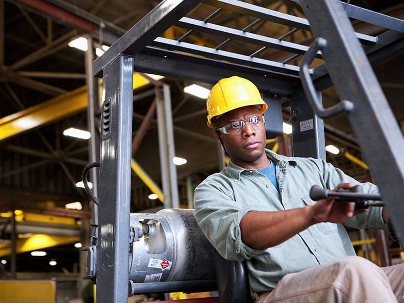 Man driving forklift.