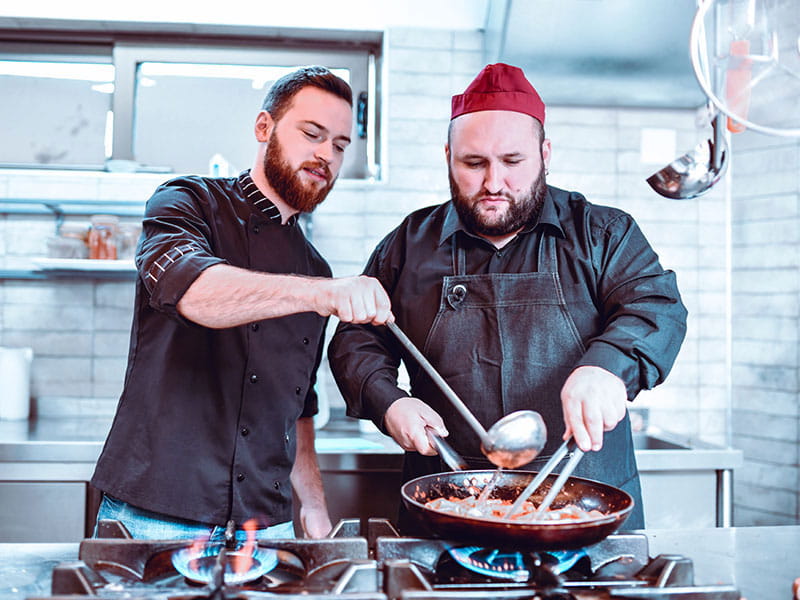Two chefs cooking.